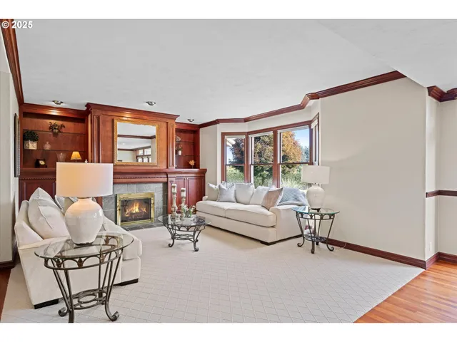 a living room with fireplace furniture and a floor to ceiling window