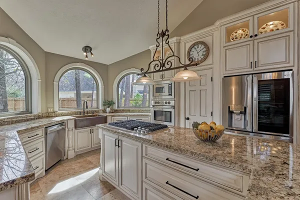 a kitchen with stainless steel appliances granite countertop a stove and a refrigerator