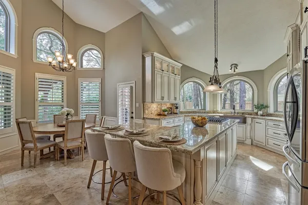 a view of a dining room with furniture and chandelier
