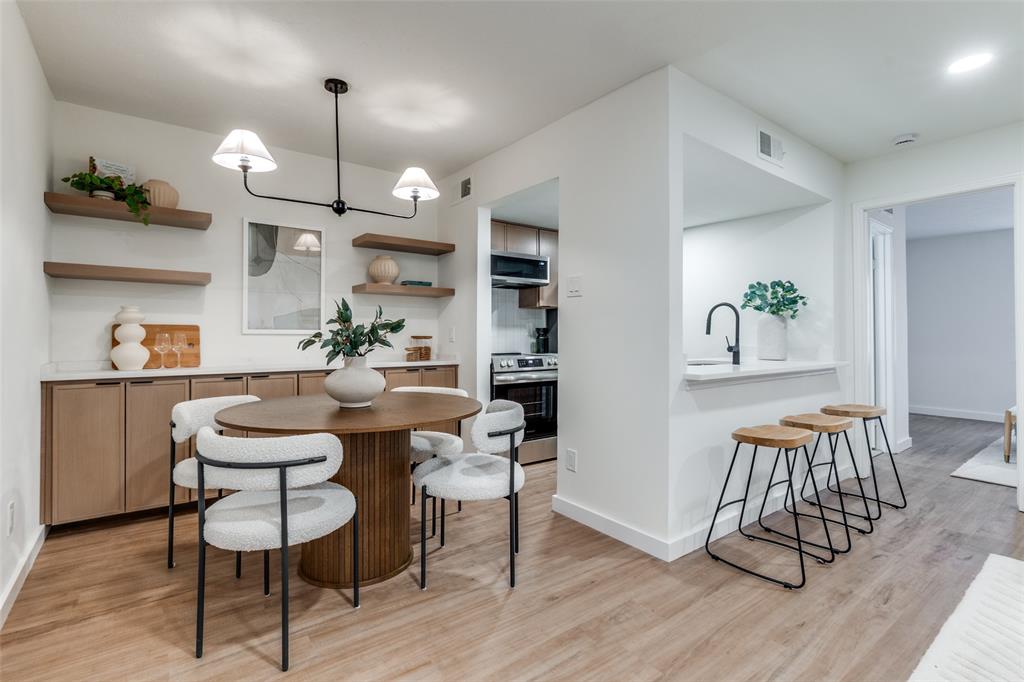 4525 Gilbert Avenue, Unit 202 Dallas, TX 75219 - Photo 1 of 13 a view of a dining room with furniture wooden floor and a chandelier
