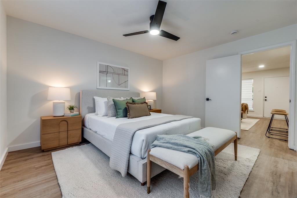 4525 Gilbert Avenue, Unit 202 Dallas, TX 75219 - Photo 11 of 13 a bedroom with a bed and a chair