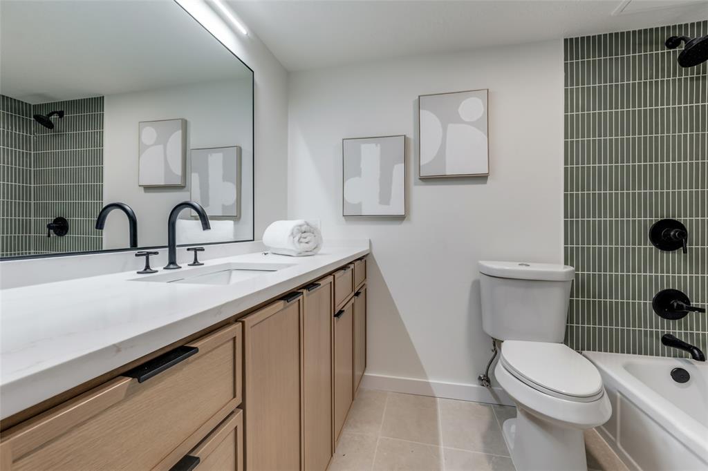 4525 Gilbert Avenue, Unit 202 Dallas, TX 75219 - Photo 12 of 13 a bathroom with a sink a toilet and mirror