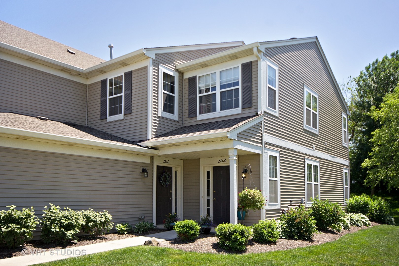 2460 Oneida Lane, Unit 2460 Naperville, IL 60563 - Photo 1 of 16 a front view of a house with garden and plants