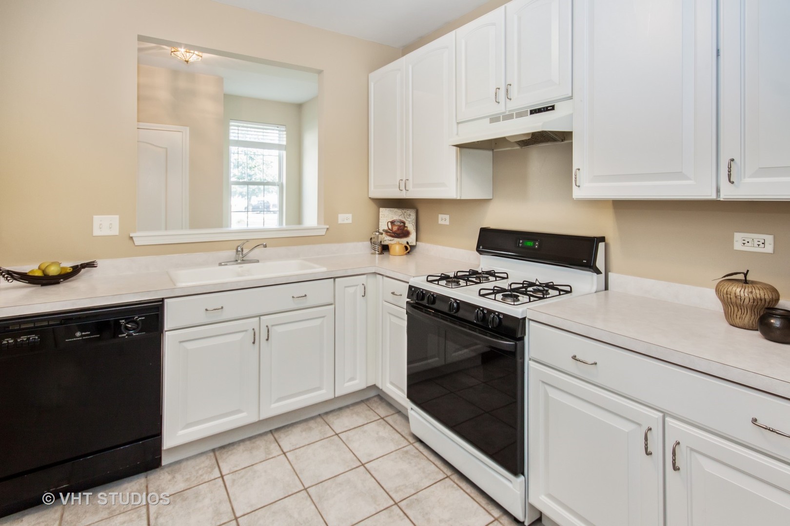 2460 Oneida Lane, Unit 2460 Naperville, IL 60563 - Photo 9 of 16 a kitchen with white cabinets and appliances