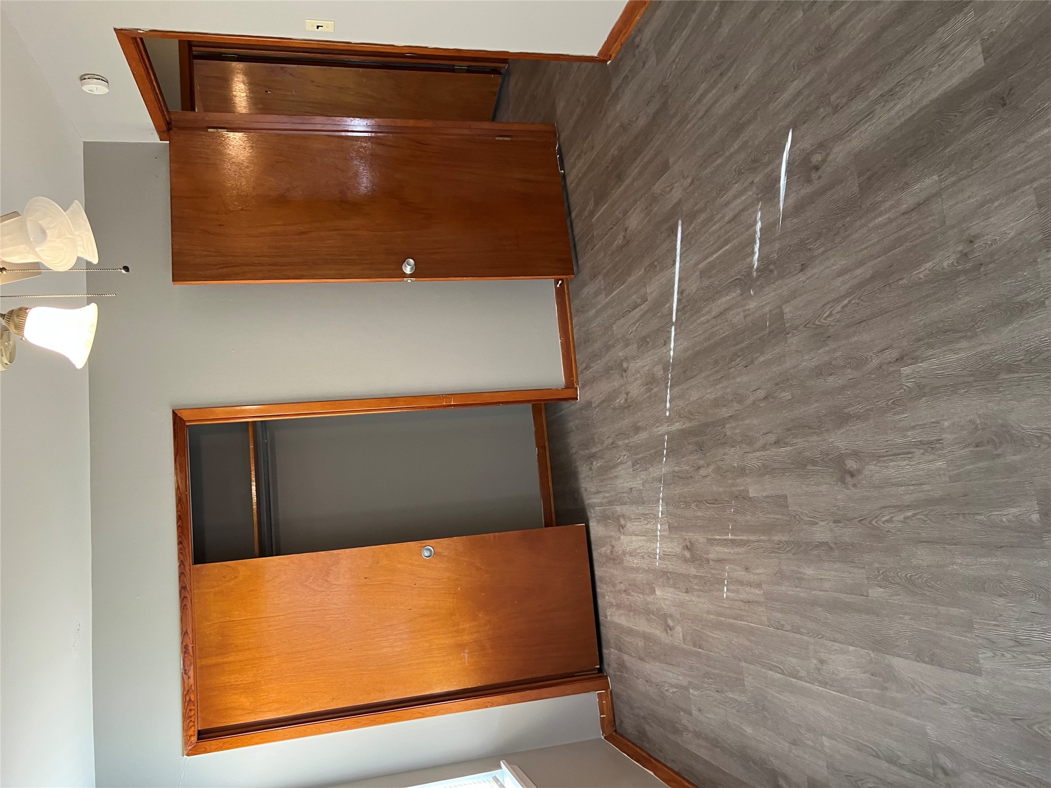 709 West 11th Street Elgin, TX 78621 - Photo 5 of 12 Unfurnished bedroom with a closet, a ceiling fan, and dark wood-type flooring
