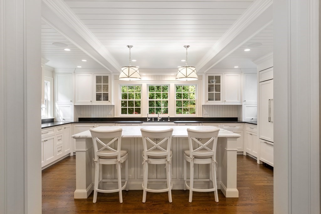 109 Edmunds Road Wellesley, MA 02481 - Photo 13 of 29 a kitchen with stainless steel appliances kitchen island granite countertop a table and chairs in it