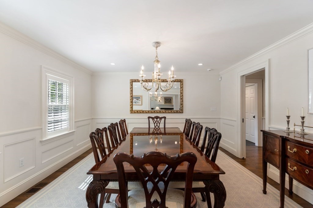 109 Edmunds Road Wellesley, MA 02481 - Photo 9 of 29 a dining room with furniture a rug and a chandelier