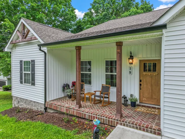 a view of house with backyard space and porch