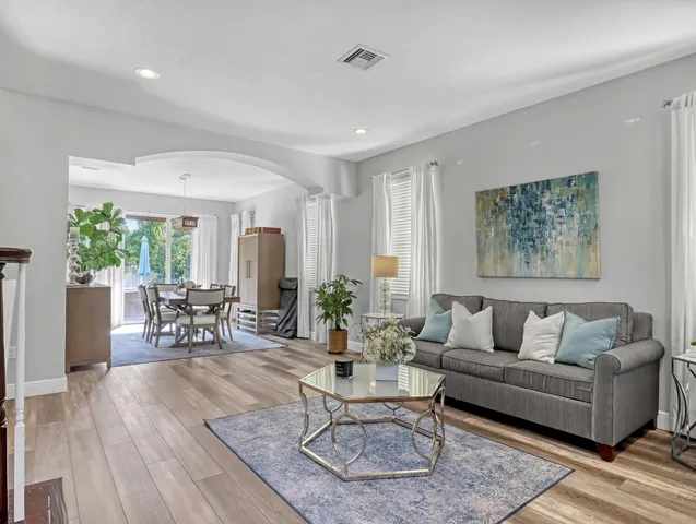 a view of a dining room with furniture window and wooden floor