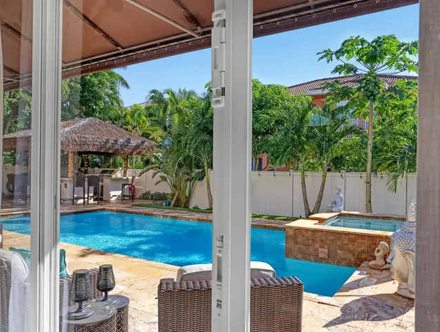 a kitchen with stainless steel appliances granite countertop white cabinets and white appliances