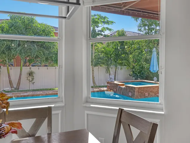 a bathroom with a tub a sink and a window