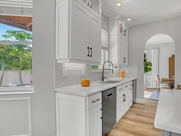 a bedroom with furniture and a large window