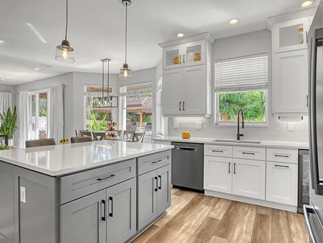 a spacious bedroom with a bed and a chandelier