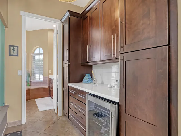 a view of a patio with table and chairs with wooden floor and fence