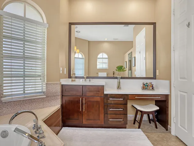 a view of a patio with chairs and a table and chairs under an umbrella