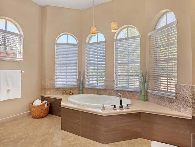 a view of a patio with a table and chairs under an umbrella