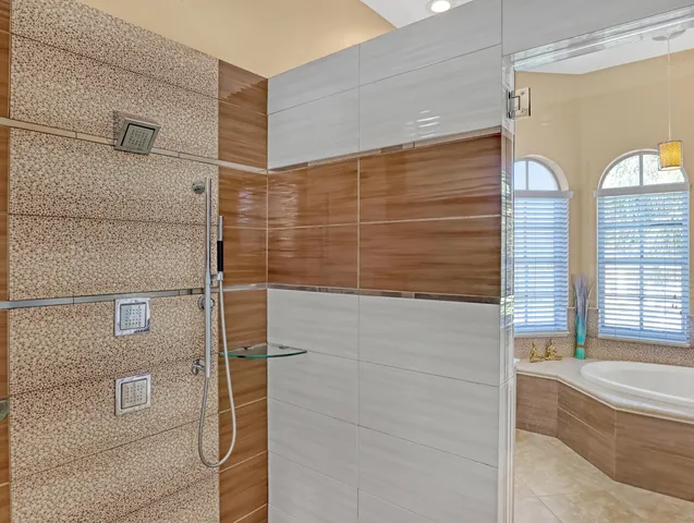 an aerial view of a city with lots of residential buildings ocean and mountain view in back