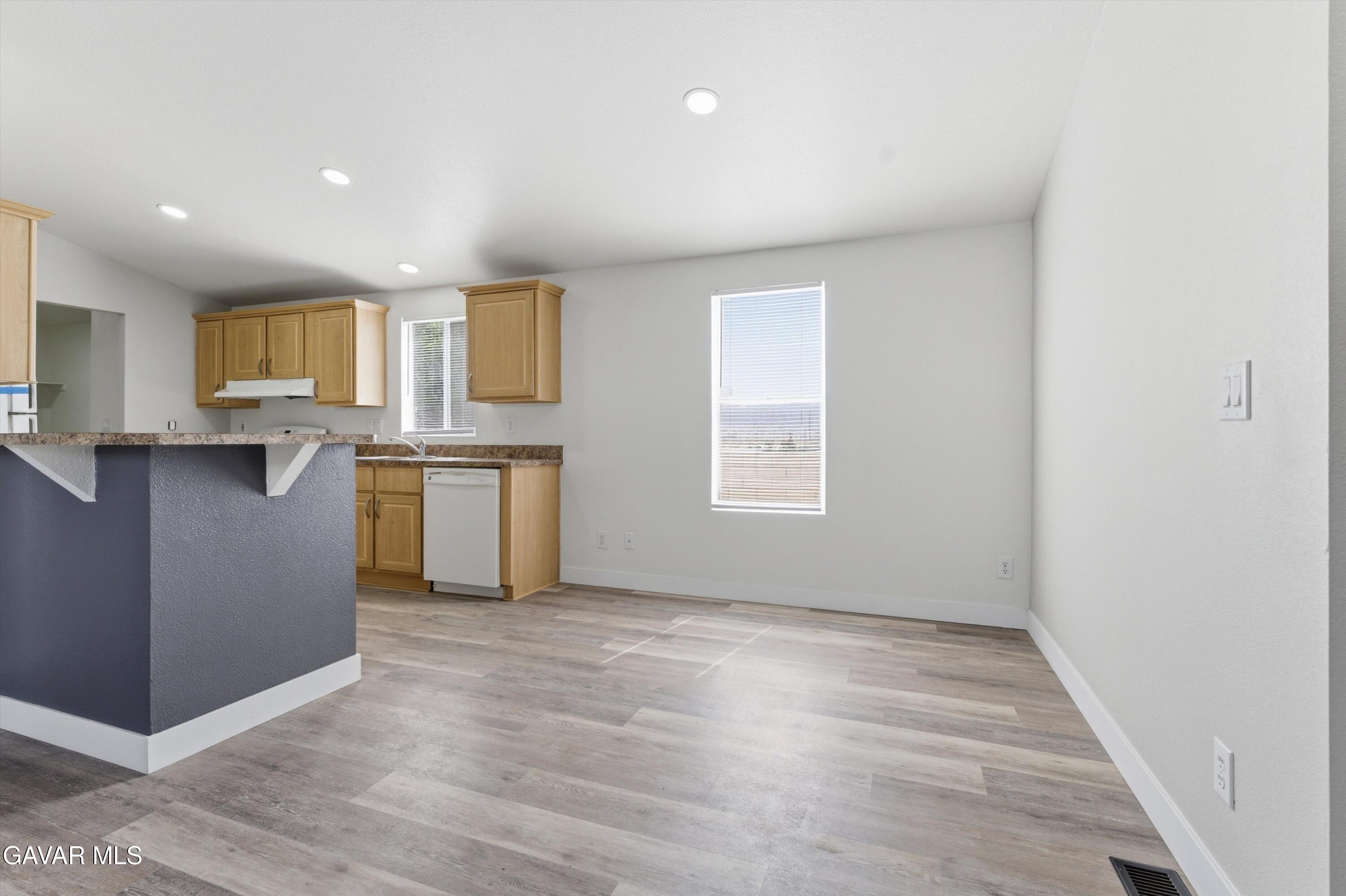 20843 Waalew Road Apple Valley, CA 92307 - Photo 9 of 40 a view of a kitchen with a sink wooden floor and a window