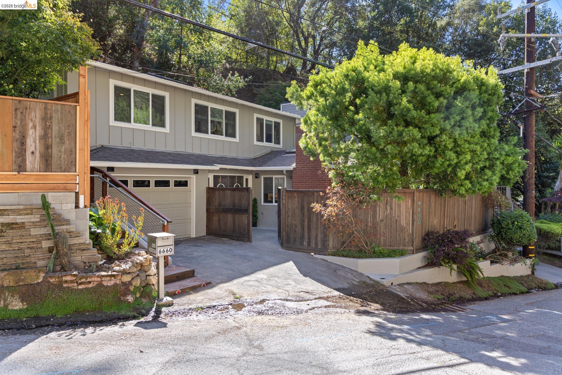 6660 Sobrante Road Oakland, CA 94611 - Photo 47 of 48 Two-story exterior with light gray siding and white trim windows