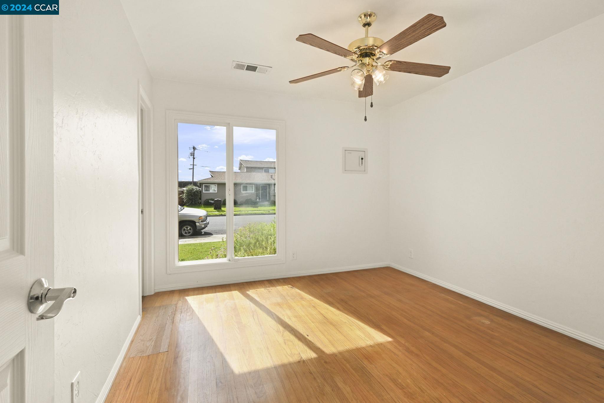 Undisclosed Address Dublin, CA 94568 - Photo 19 of 28 an empty room with a window and a ceiling fan