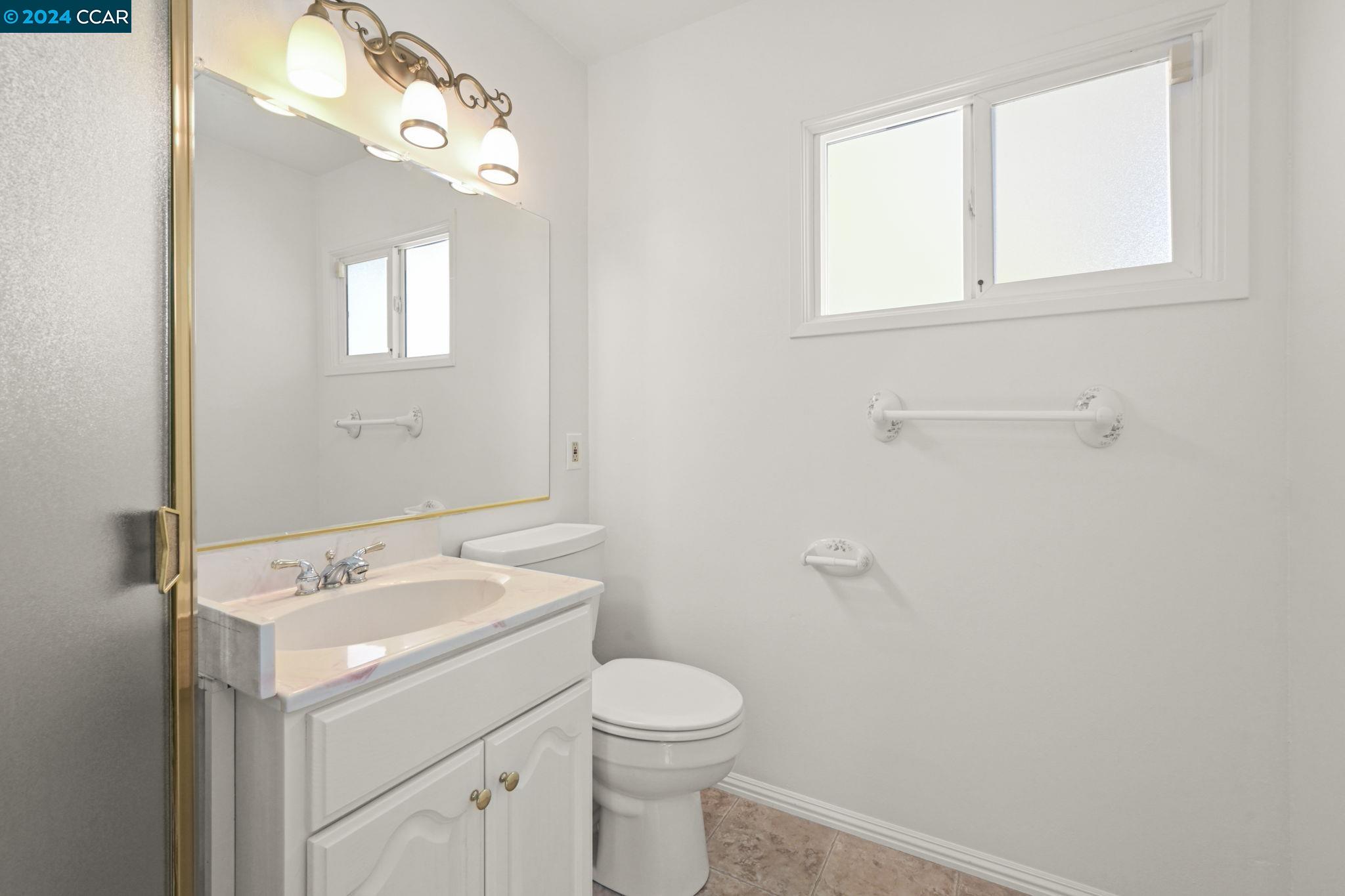 Undisclosed Address Dublin, CA 94568 - Photo 20 of 28 a bathroom with a sink a toilet and a mirror