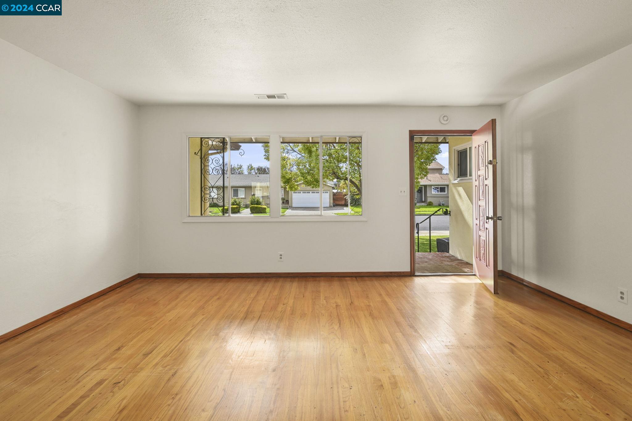 Undisclosed Address Dublin, CA 94568 - Photo 6 of 28 an empty room with wooden floor and windows