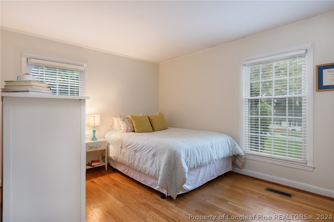2519 Huntington Road Fayetteville, NC 28303 - Photo 20 of 36 a large bed sitting in a bedroom next to a window