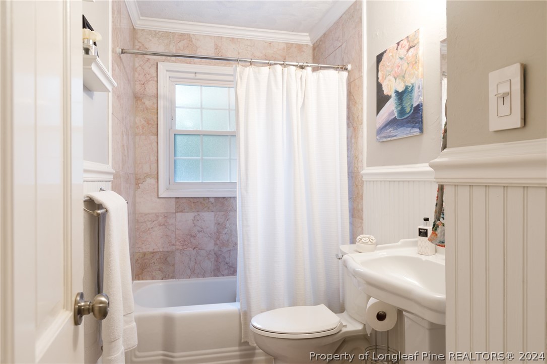 2519 Huntington Road Fayetteville, NC 28303 - Photo 22 of 36 a bathroom with a sink toilet and shower
