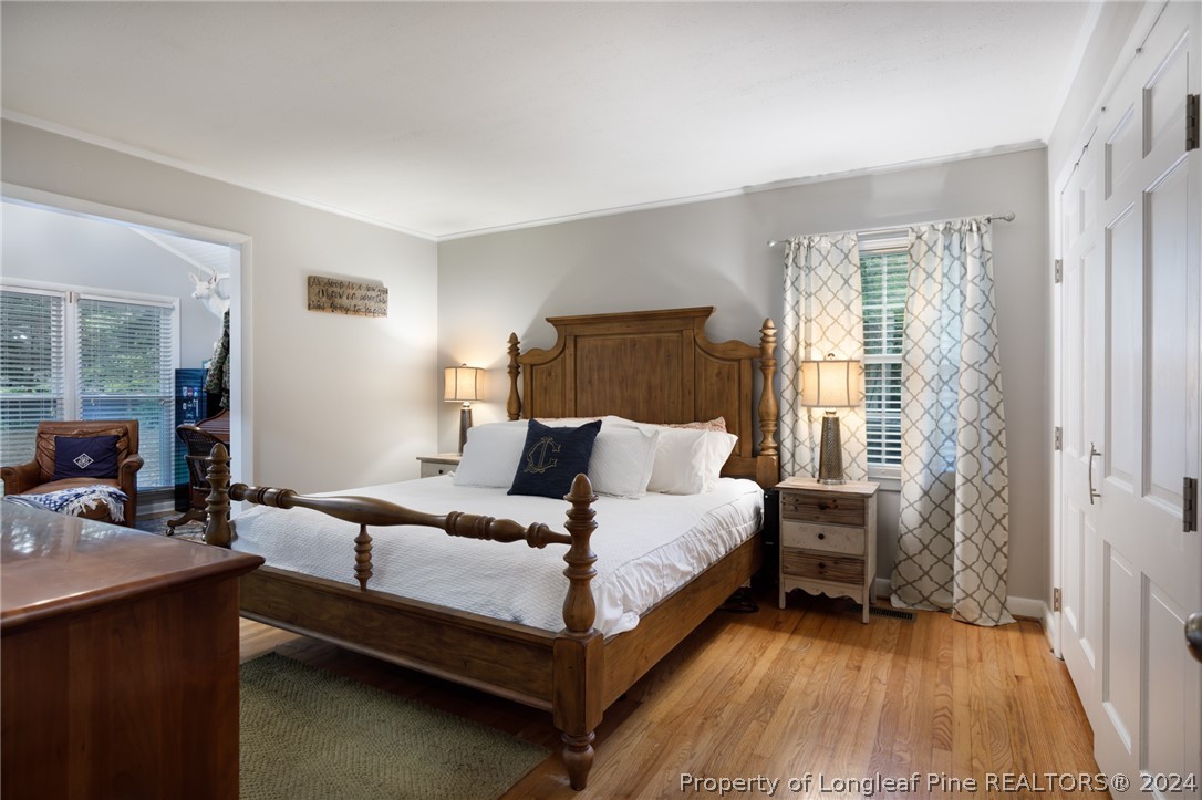 2519 Huntington Road Fayetteville, NC 28303 - Photo 24 of 36 a bedroom with a bed and wooden floor