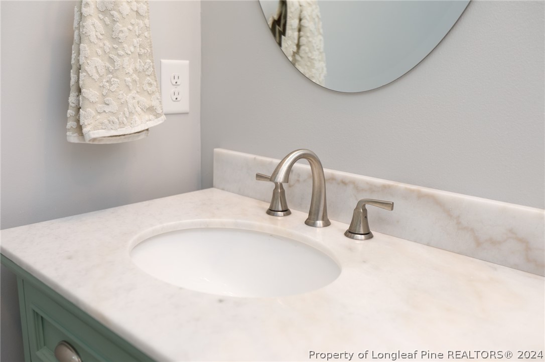 2519 Huntington Road Fayetteville, NC 28303 - Photo 29 of 36 a close view of a sink and a mirror in a bathroom