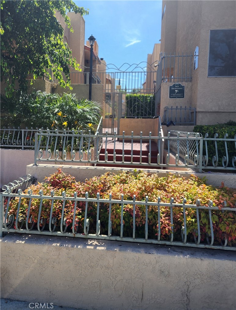 10260 Plainview Avenue, Unit 31 Tujunga, CA 91042 - Photo 1 of 1 a view of a water fountain and a building in the background