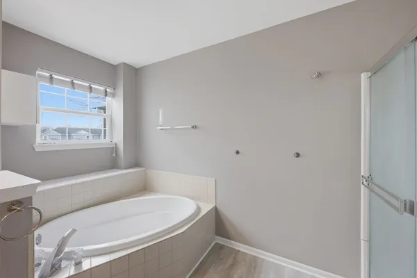 a bathroom with a bathtub and window