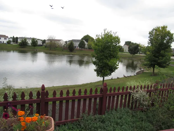 a view of a lake with houses in the back