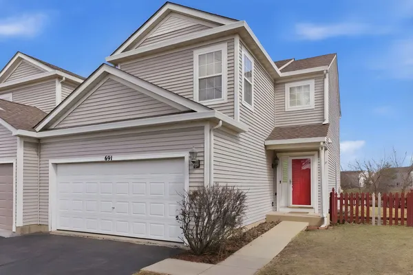 a front view of a house with a garage