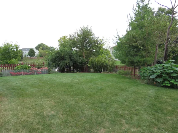 a view of yard with swimming pool and green space