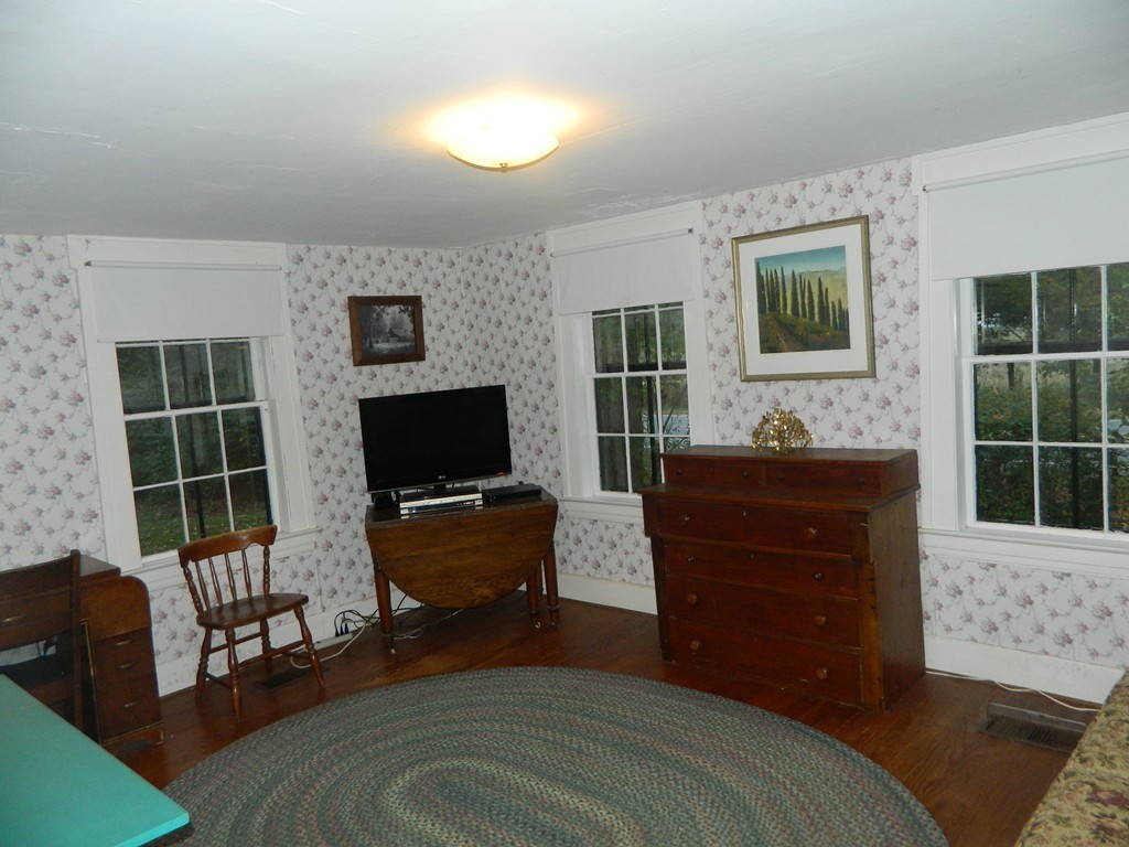 172 Long Plain Road Leverett, MA 01054 - Photo 16 of 30 a bedroom with a bed and wooden floor