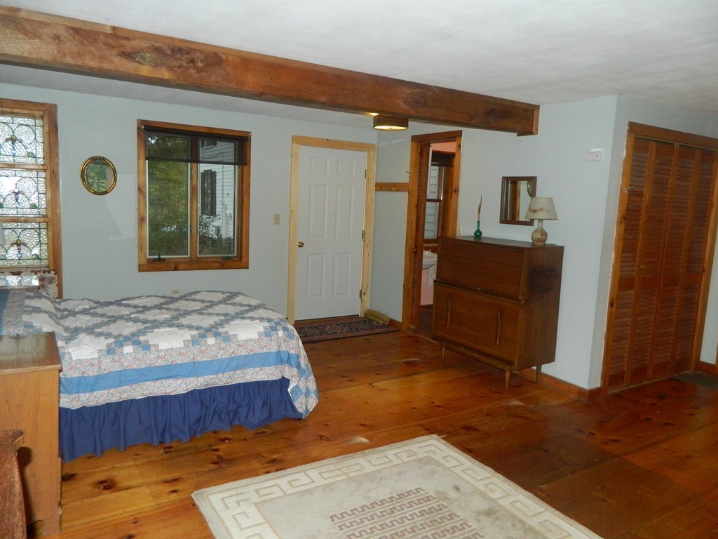 172 Long Plain Road Leverett, MA 01054 - Photo 6 of 30 a bedroom with a bed and a dresser next to a window