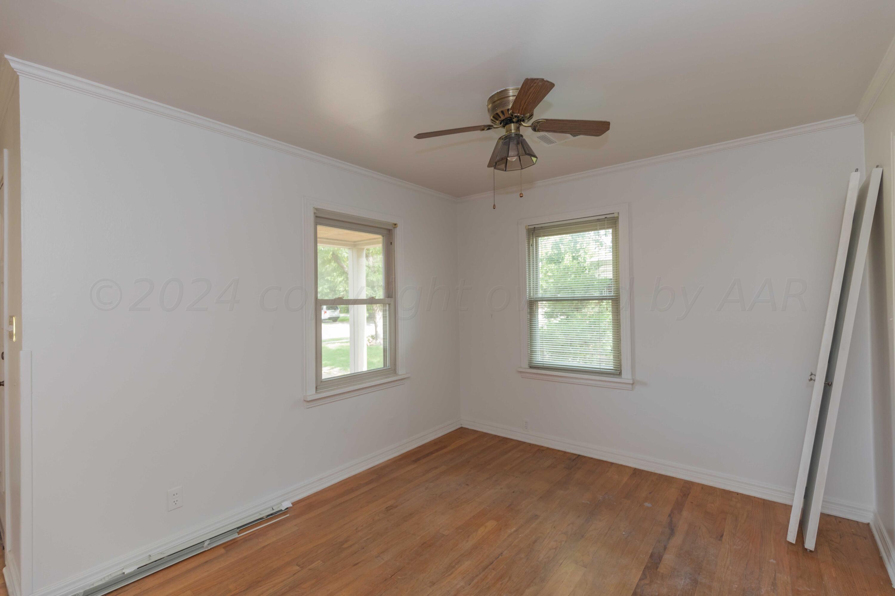1613 South Travis Street Amarillo, TX 79102 - Photo 11 of 49 a view of an empty room with a window