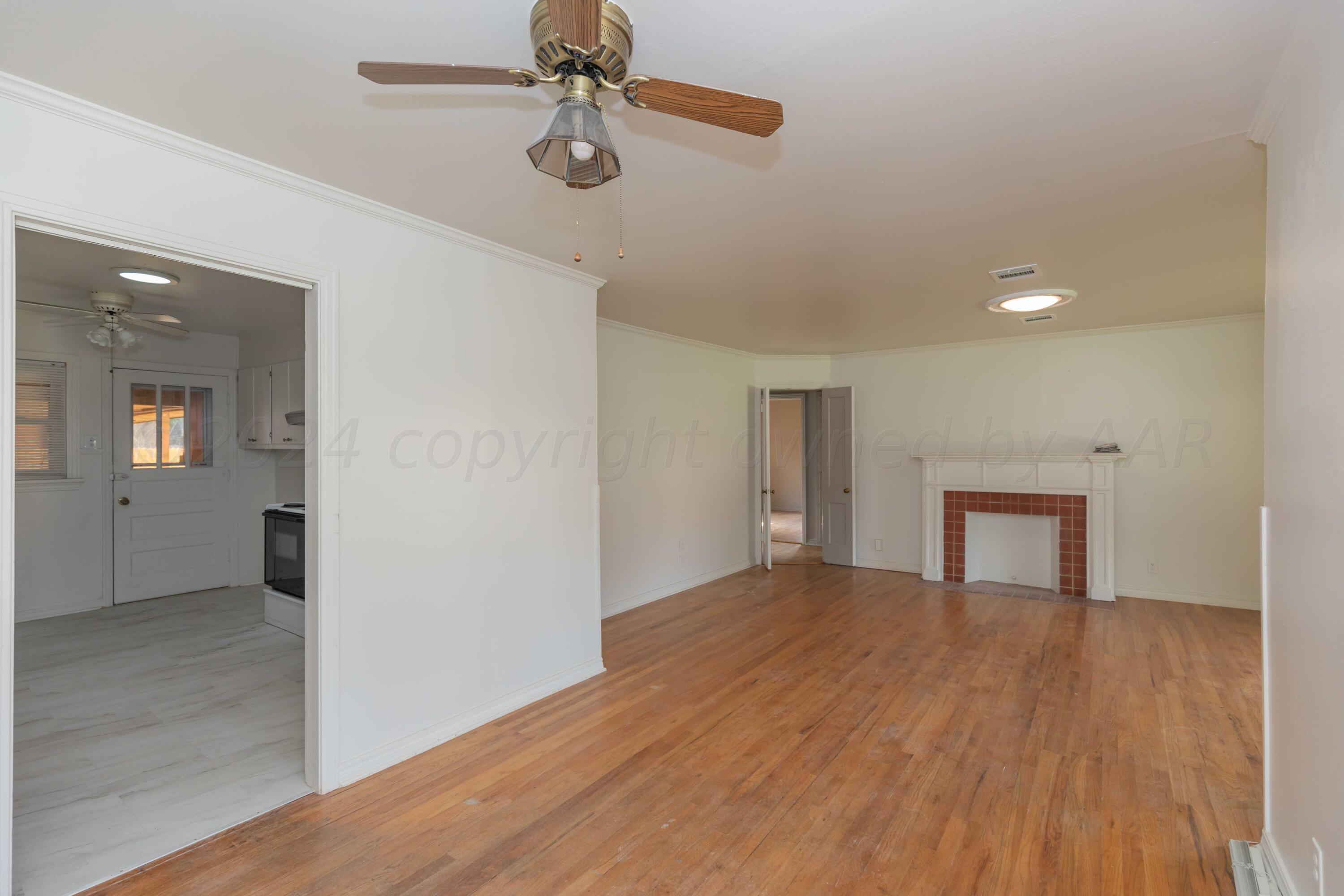 1613 South Travis Street Amarillo, TX 79102 - Photo 12 of 49 a view of empty room with wooden floor