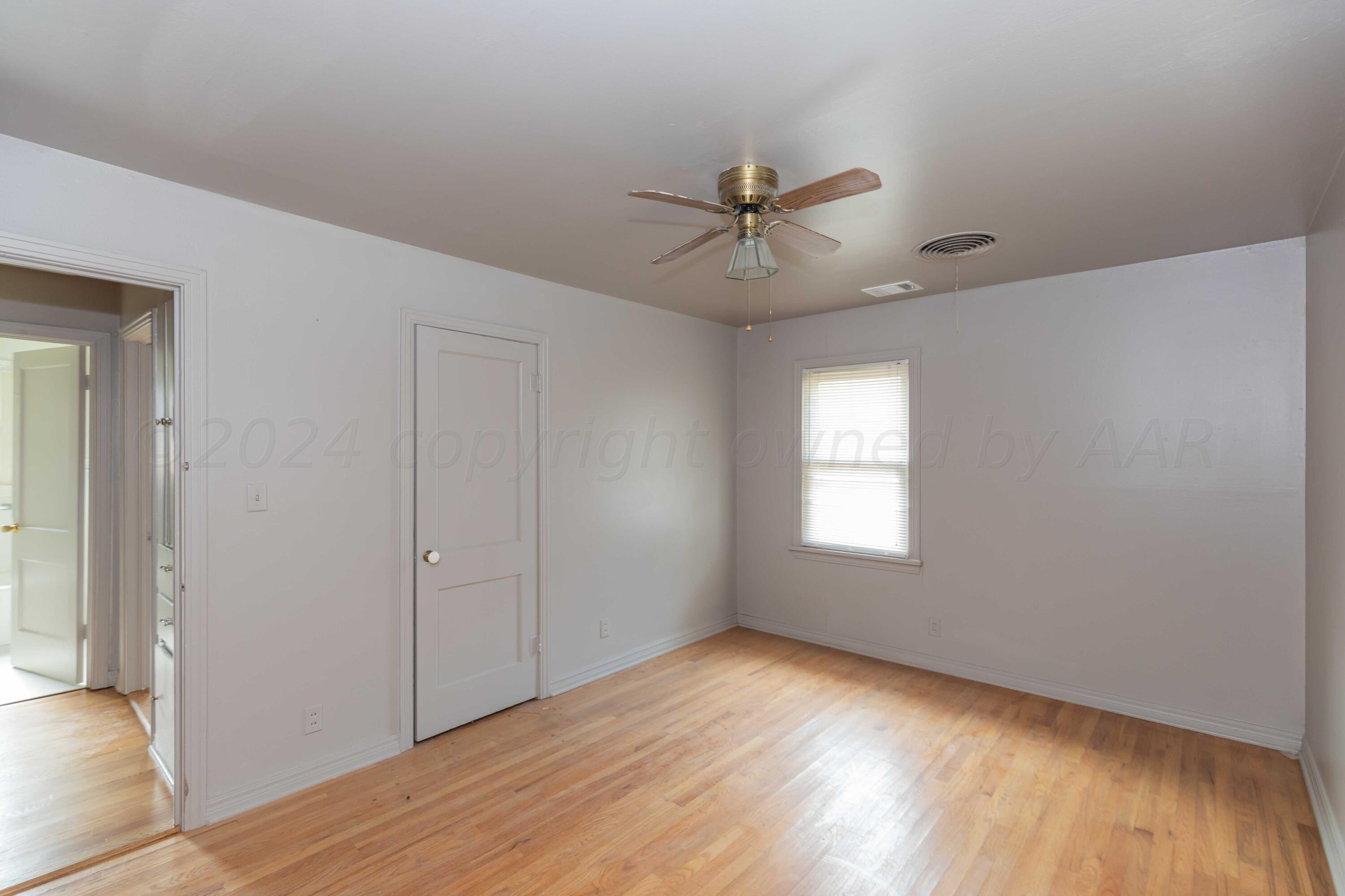 1613 South Travis Street Amarillo, TX 79102 - Photo 18 of 49 a view of empty room with wooden floor and fan