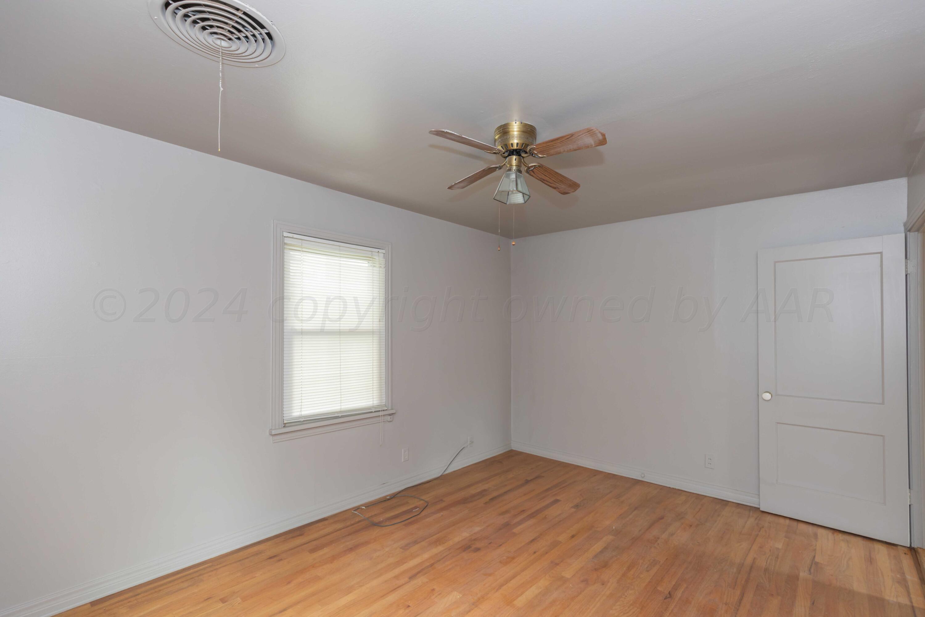 1613 South Travis Street Amarillo, TX 79102 - Photo 20 of 49 a view of a big room with wooden floor and windows