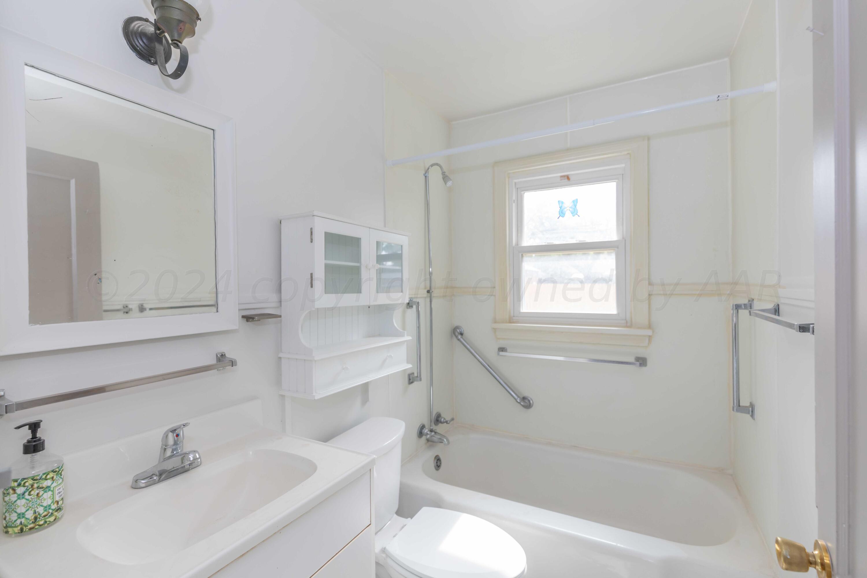 1613 South Travis Street Amarillo, TX 79102 - Photo 22 of 49 a bathroom with a sink toilet and shower
