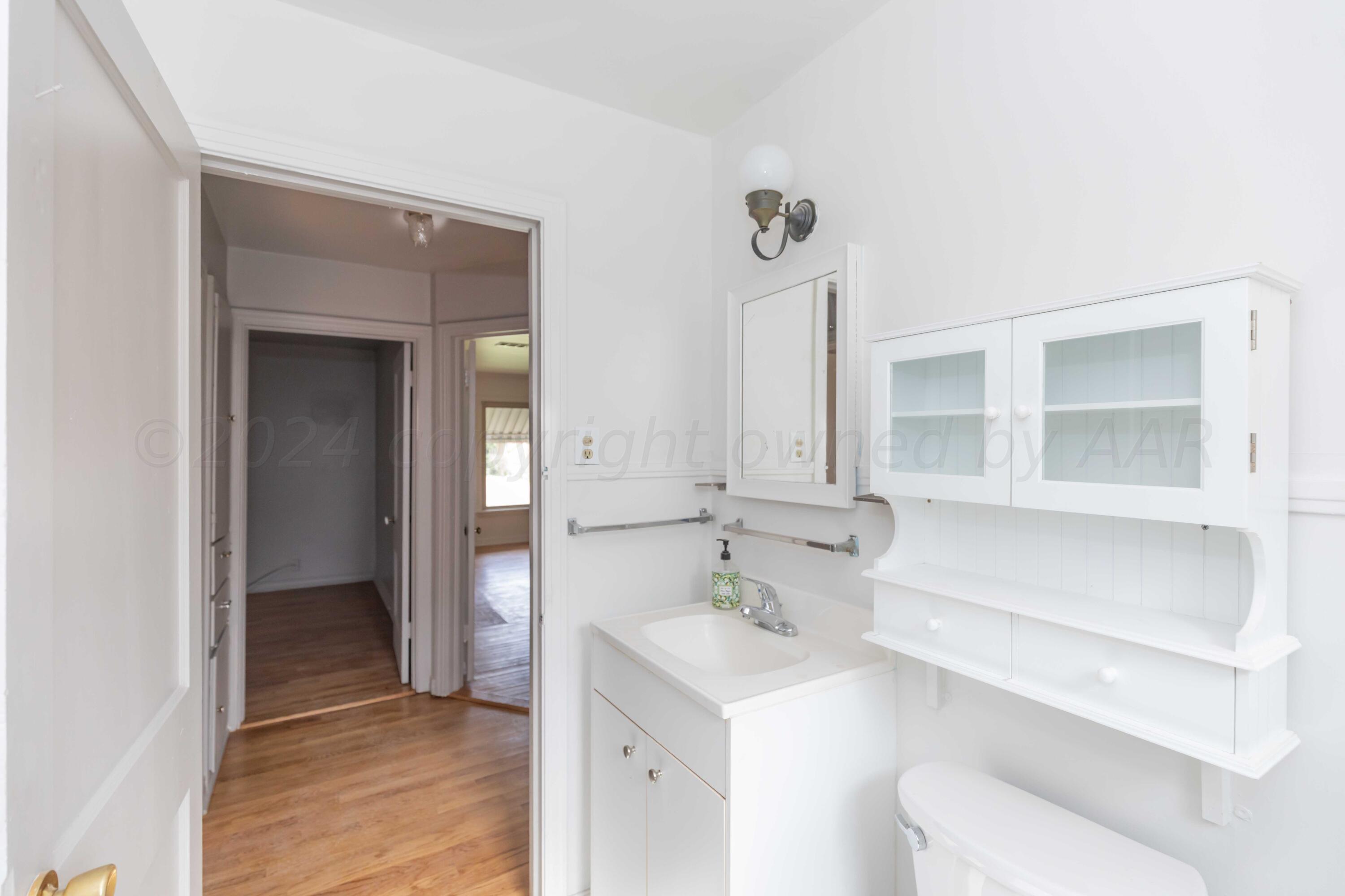 1613 South Travis Street Amarillo, TX 79102 - Photo 23 of 49 a bathroom with a sink toilet and shower