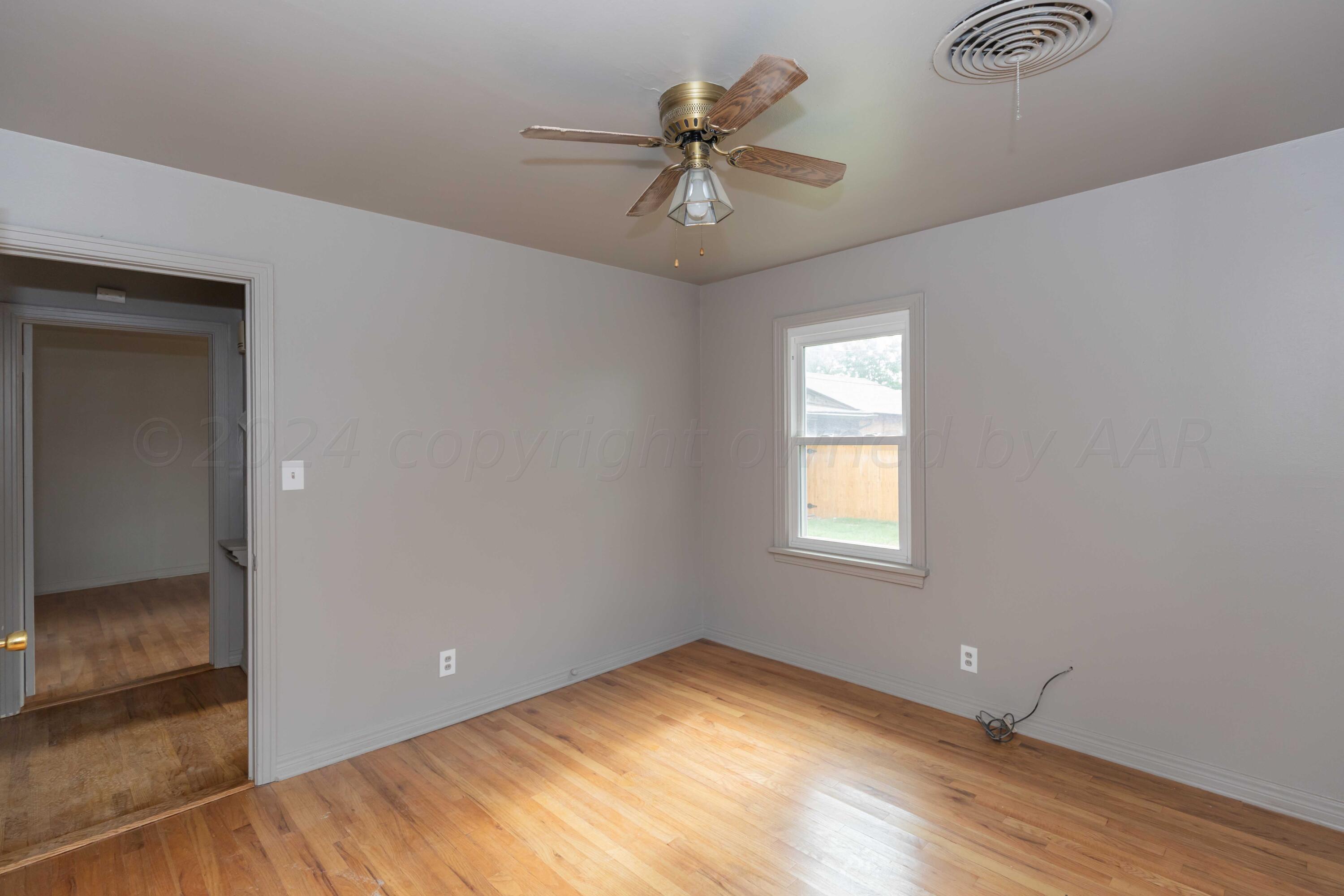 1613 South Travis Street Amarillo, TX 79102 - Photo 25 of 49 an empty room with fan and windows