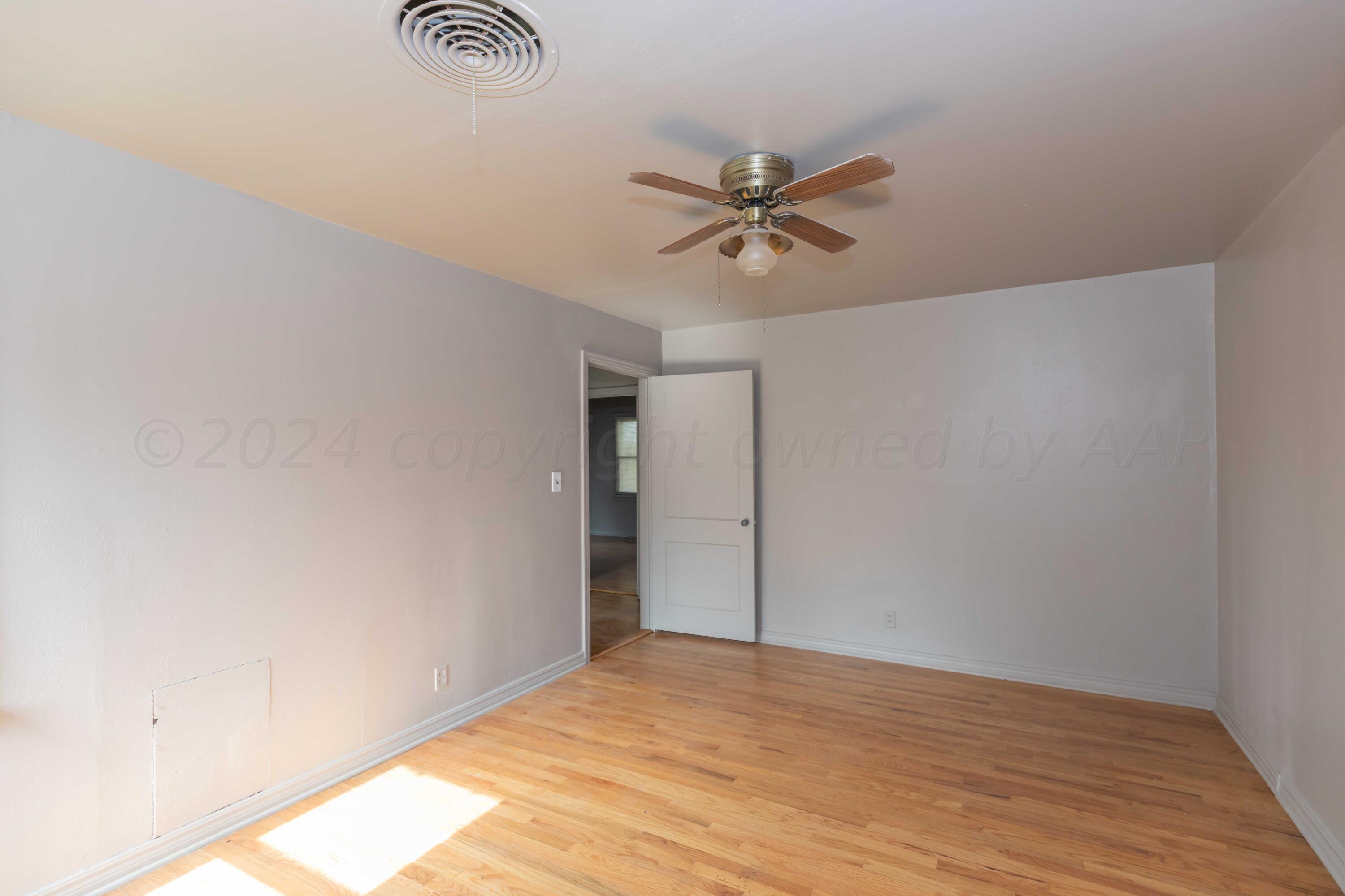 1613 South Travis Street Amarillo, TX 79102 - Photo 28 of 49 a view of empty room with wooden floor