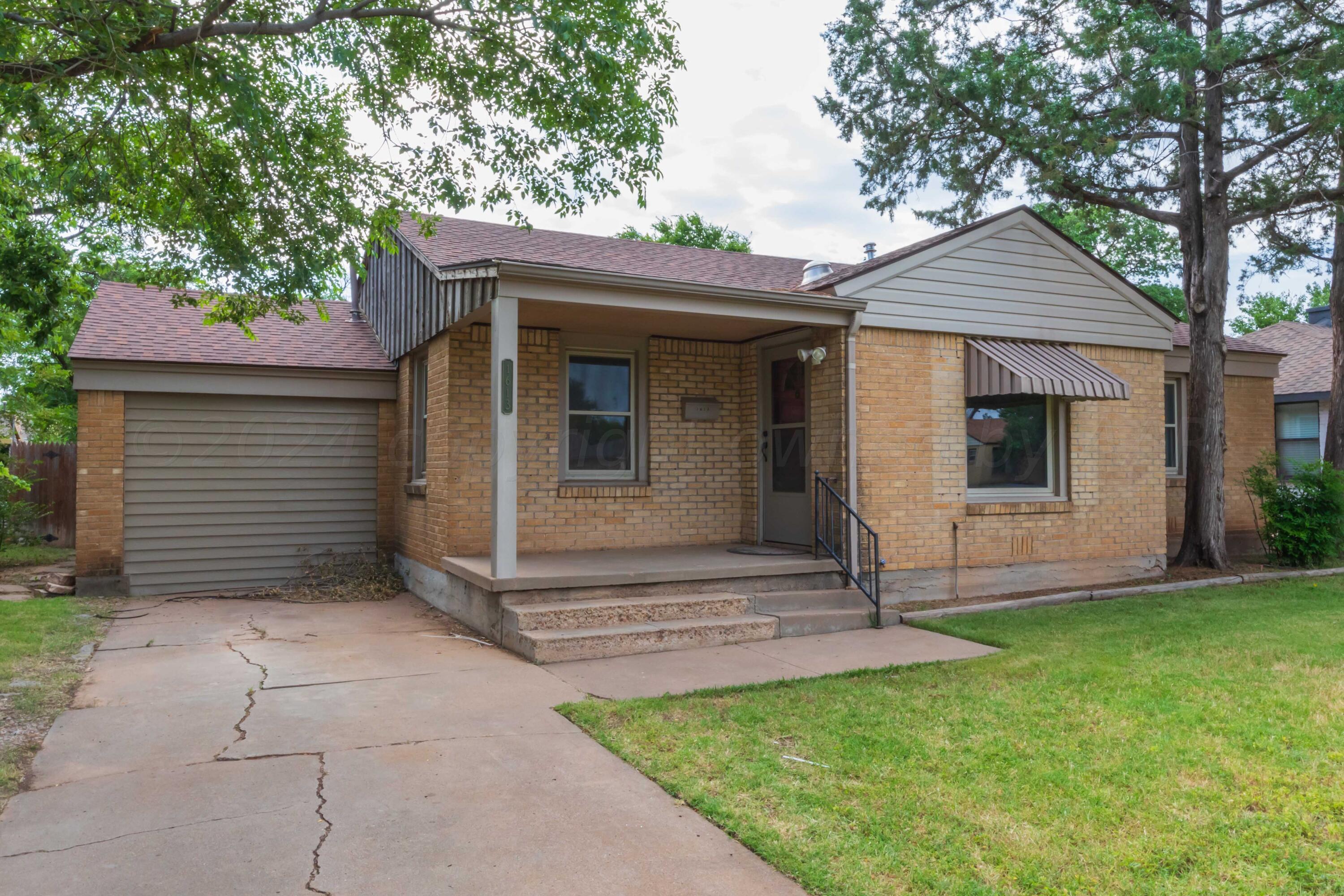 1613 South Travis Street Amarillo, TX 79102 - Photo 3 of 49 a view of a house with a yard