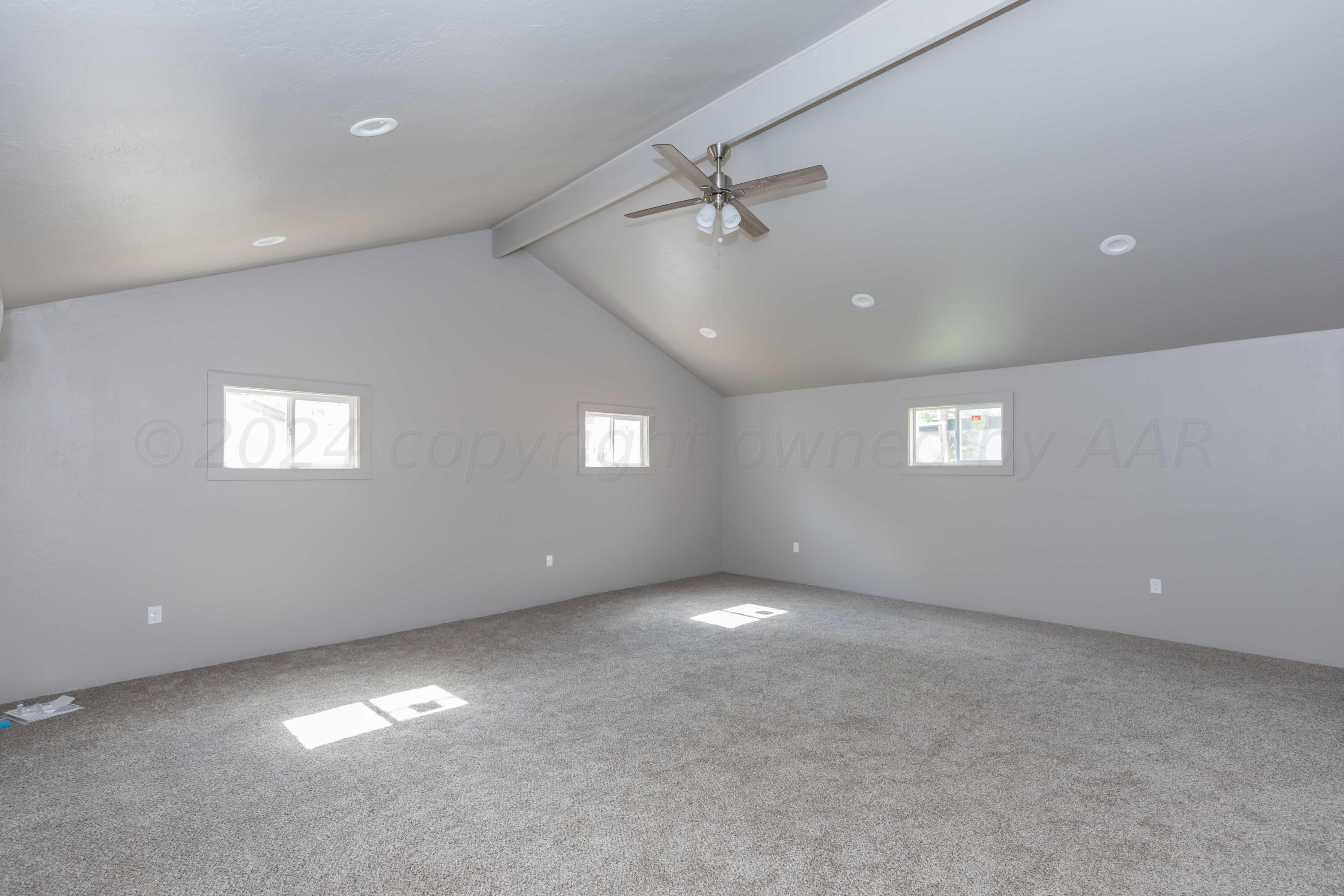 1613 South Travis Street Amarillo, TX 79102 - Photo 39 of 49 an empty room with windows and fan