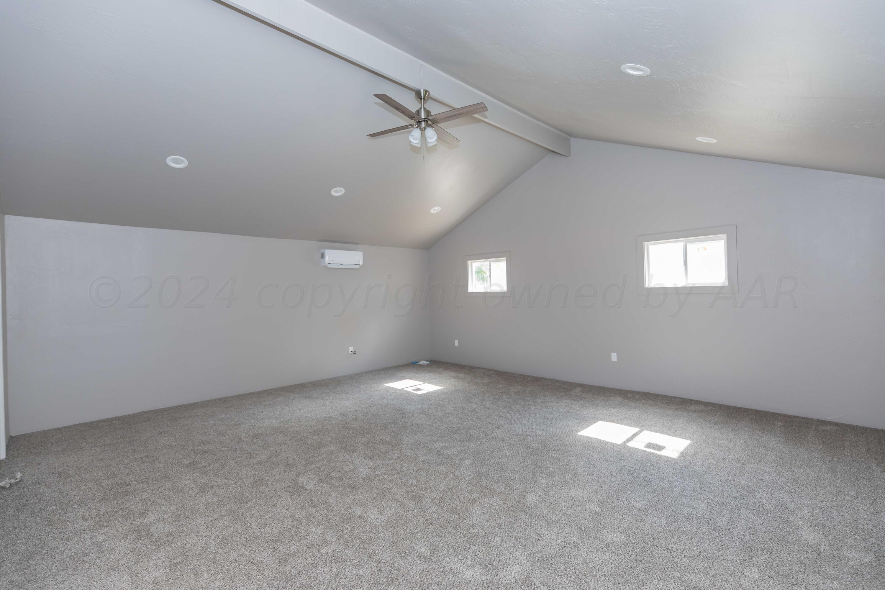 1613 South Travis Street Amarillo, TX 79102 - Photo 42 of 49 an empty room with windows and ceiling fan view