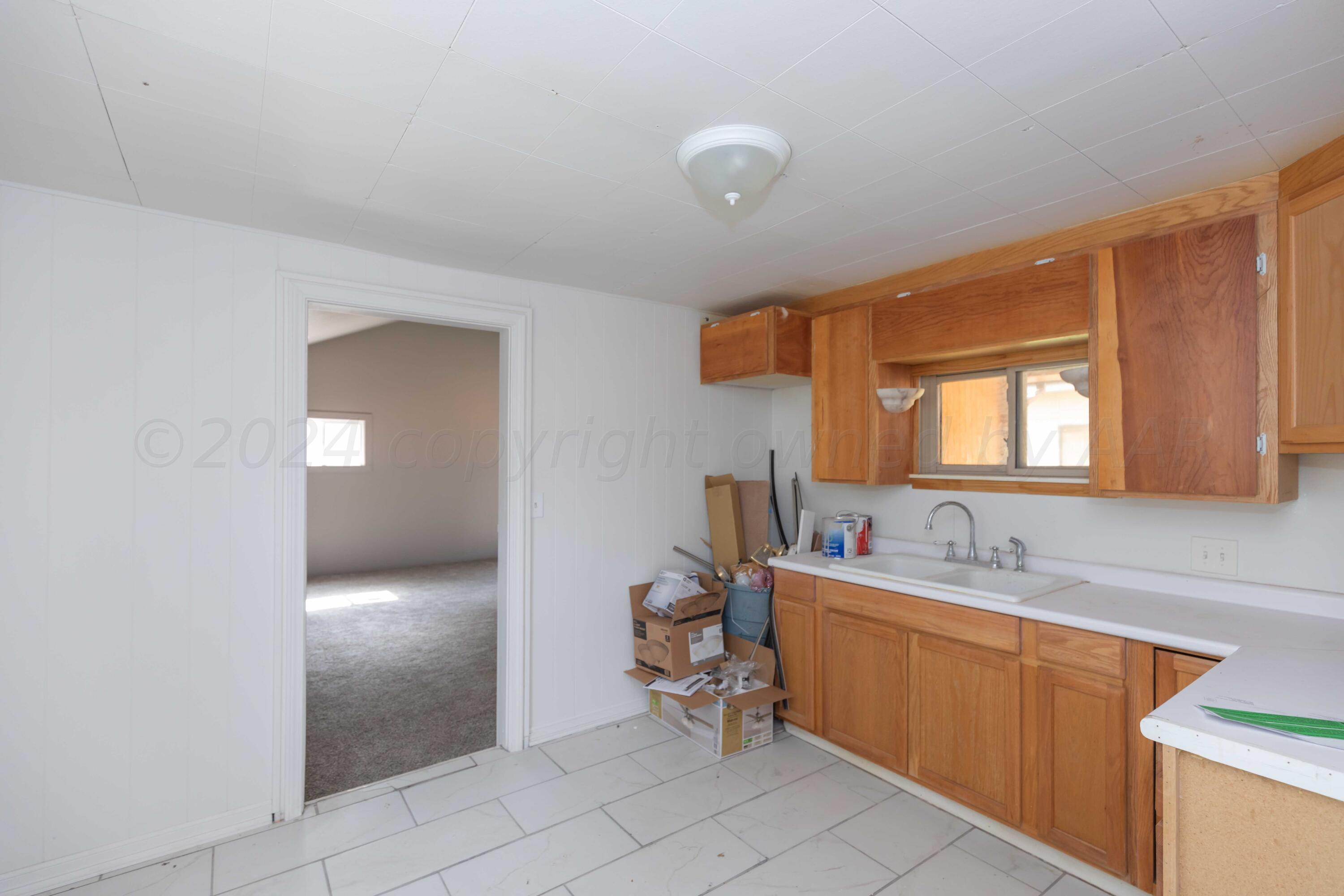1613 South Travis Street Amarillo, TX 79102 - Photo 43 of 49 a bathroom with a sink and a mirror