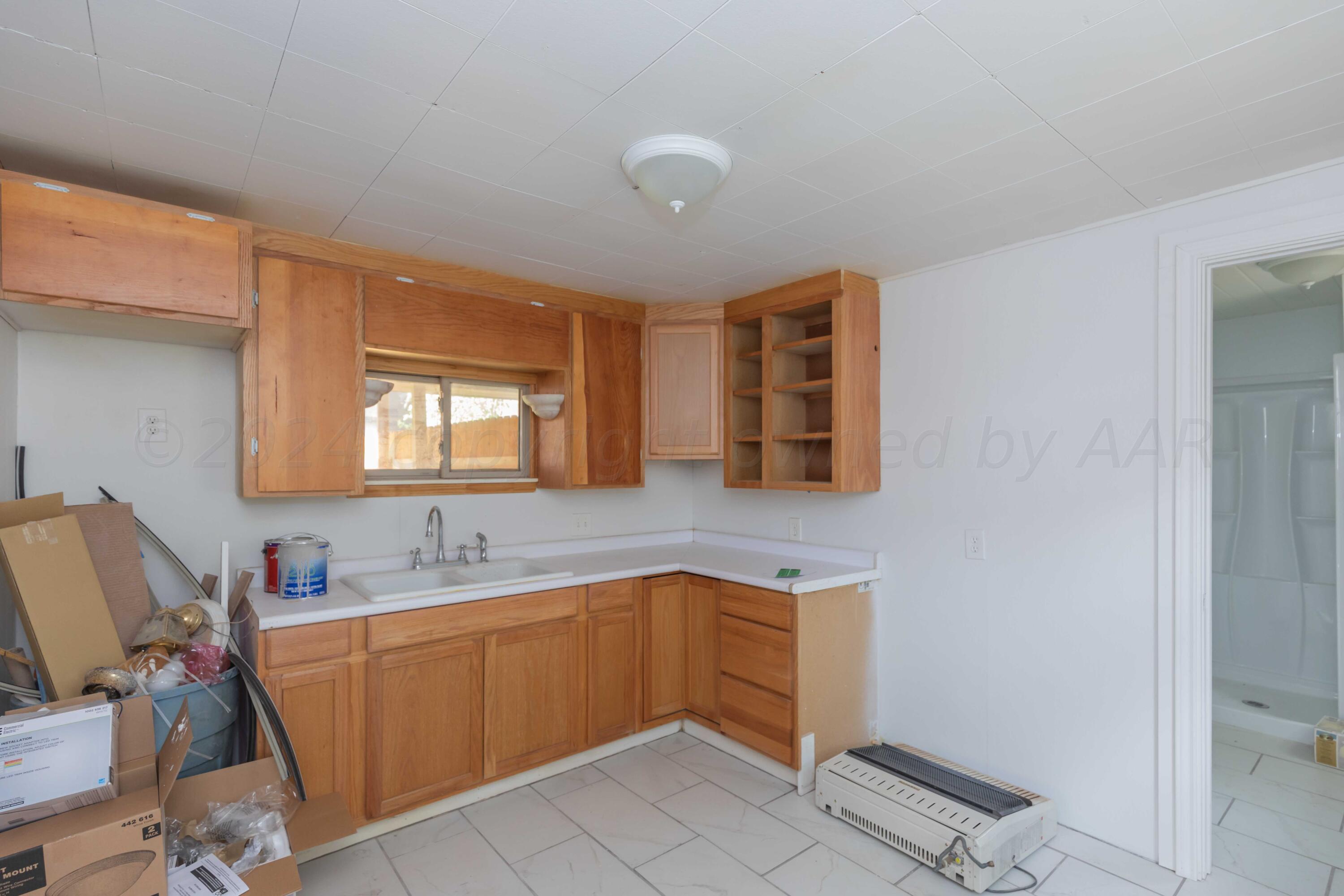 1613 South Travis Street Amarillo, TX 79102 - Photo 44 of 49 a kitchen with a sink cabinets and window